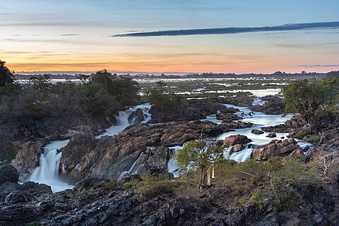 Li Phi falls with colorful sky from elevated zip line platform at sunset in Don Khon Si Phan Don Laos