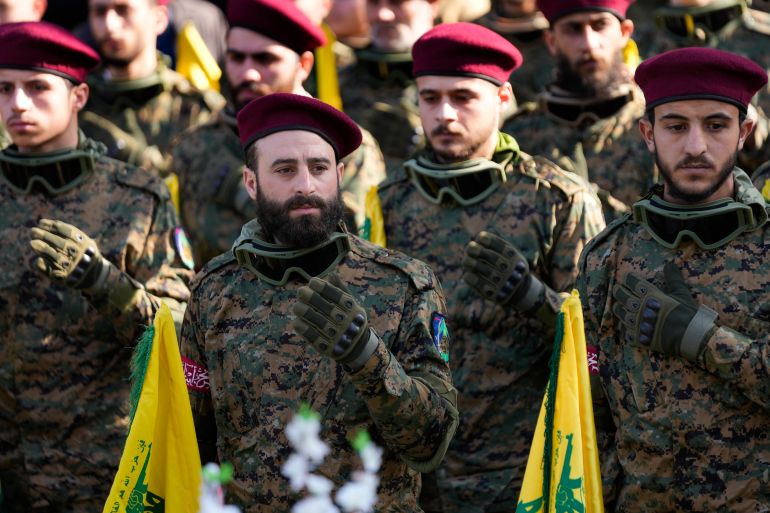 Hezbollah fighters mourn as they attend the funeral procession of their senior commander Wissam al-Tawil, during his funeral procession in the village of Khirbet Selm, south Lebanon, Tuesday, Jan. 9, 2024. The elite Hezbollah commander who was killed in an Israeli airstrike Monday in southern Lebanon fought for the group for decades and took part in some of its biggest battles. (AP Photo/Hussein Malla)