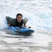 Elsie Berriman is surfing to school from Hayle to Carbis Bay