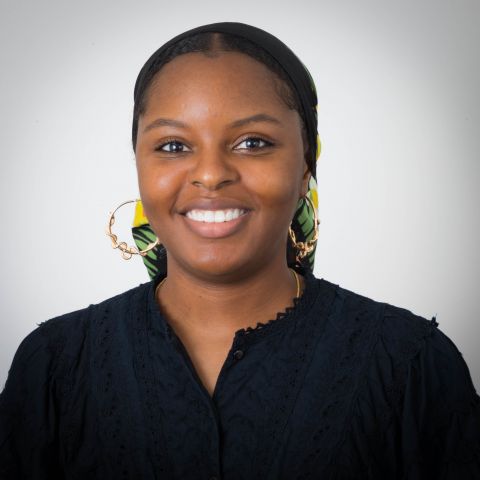 Headshot of Maurika Smutherman, an African-American woman wearing a black scarf, gold hoop earrings, and a black shirt.