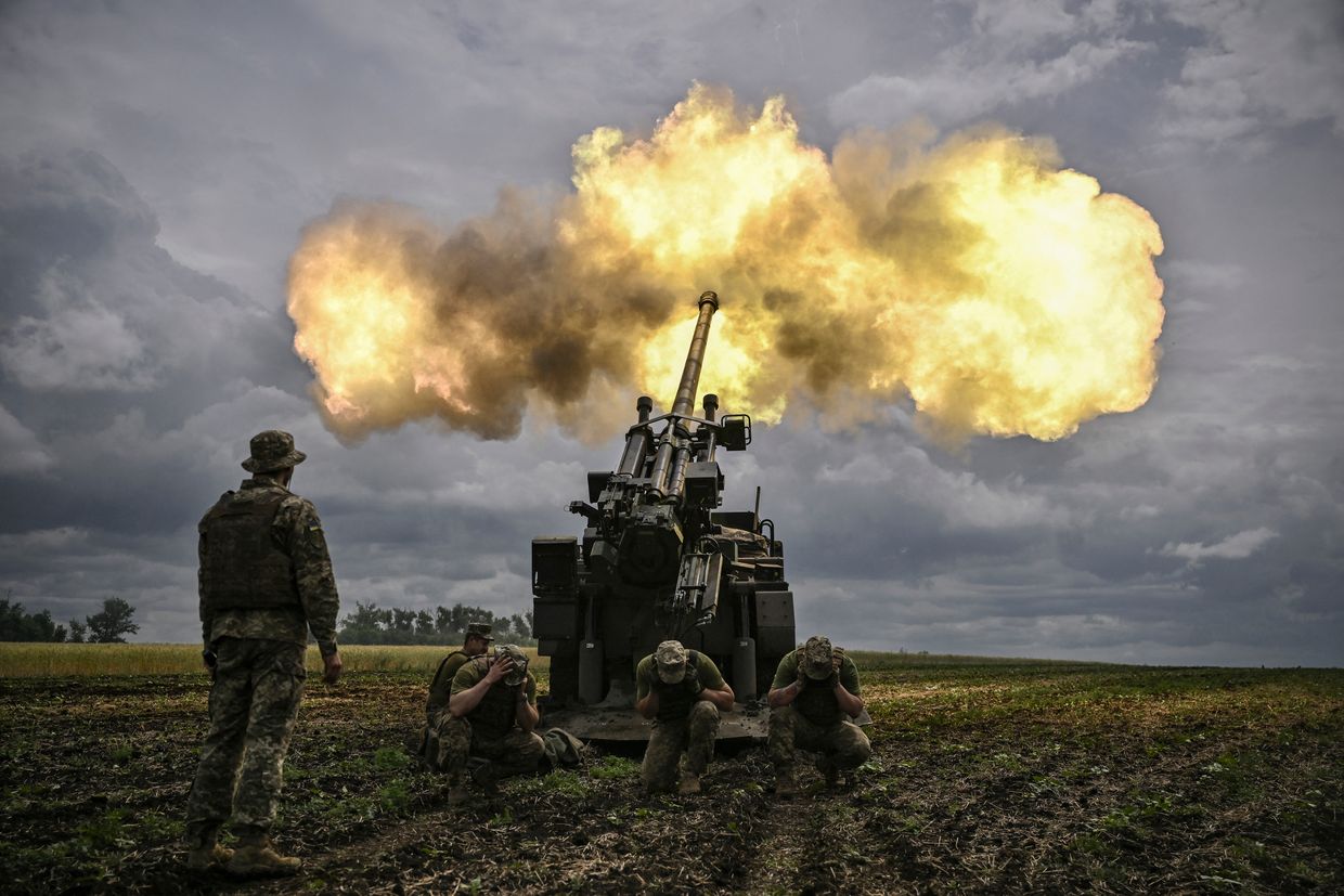 Ukrainian servicemen fire with a French self-propelled 155 mm/52-calibre gun Caesar 