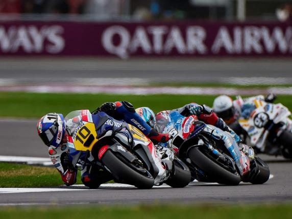 Respol Honda Team's Italian rider Luca Marini (L) takes part in a warm-up ahead of the MotoGP race of British Grand Prix at Silverstone circuit in Northamptonshire, central England, on August 4, 2024. (Photo by BENJAMIN CREMEL / AFP)