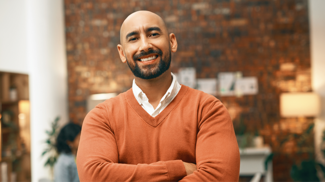 A Technical Account Manager smiling in an office space. 