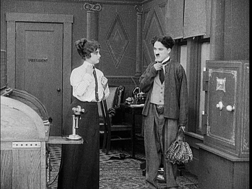 Charles Chaplin and Helen Carruthers in The New Janitor (1914)