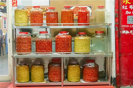 Chilis glass jars and picklings glass jars on the display cabinet of doorway right side of Hunan restaurant