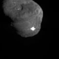 The image depicts the first moments after Deep Impact's probe interfaced with comet Tempel 1. The illuminated -- and possibly incandescent -- debris is expanding from the impact site. The rough-hewn edges at the top and bottom of the flash are a result of light given off at impact saturating some of the pixels in the camera's imager. The pixels "bleed" excess electronic charge onto adjacent pixels in the same column. This image was taken by Deep Impact's high-resolution camera.