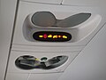 Passenger signs, lights, and vent nozzles on a Bombardier CRJ200. The speakers are ahead of the seat belt lights in this perspective, and the attendant call button is the oval button ahead of the reading lights.