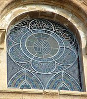 Exterior of a window at Sé Velha de Coimbra, Portugal, showing a modern steel armature.