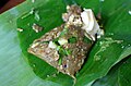 'Tam makhuea': Chopped grilled long green eggplant, grilled green chillies, raw garlic and salt put in a banana leaf package mixed together with cooked egg