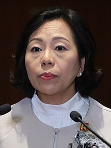 Headshot photograph of a frowning Chinese woman with short hair