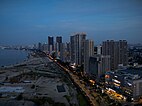 Aerial view of Gurney Drive, lined with skyscrapers, at dusk