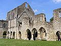 Cloister comprising the south transept and the east range: entrance to the chapter house is through the centre triple arches.