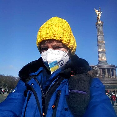 Participant in the large demonstration in Berlin, against the Russian invasion of Ukraine wearing a yellow knitted hat and blue anorak