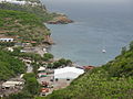 A view of half of the coastline of Little Bay, and a glimpse of Carrs Bay, taken from partway up the headland between Little Bay and Rendezvous Bay, 2012