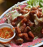 Sai mu thot, deep-fried pork intestines, here served with spicy nam chim (Thai dipping sauce)