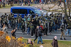 A group of armed troopers in casual clothes