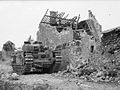 A Churchill tank in the shattered village of Maltot, 26 July 1944.