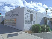 The Watson's Flowers Building was built in 1920 and is located at 2525 E. Apache Blvd. The building is an example of adobe commercial construction and the Art Moderne style. It is historically associated to Tempe's transportation and tourism. The property is listed in the Tempe Historic Property Register.