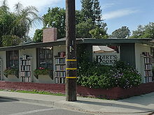 A front view of the bookstore. Bookshelves are in front of the building's walls.