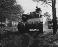 A medium tank M3 Lee and a trainee of the armored forces completing the course at Fort Benning, Georgia, ca. 04/1942