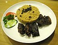 Goat nasi kebuli with raisins as garnishing.