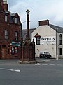 The cross in Turriff, Aberdeenshire comprises a 16th-century pillar and cruciform top raised on a 19th-century plinth