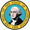 A circular seal with the words "The Seal of the State of Washington, 1889" centered around it from top to bottom. In the center, a man with gray hair poses.