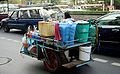 A street vendor on Rama 4 road in Bangkok with his mobile kitchen on his way to work