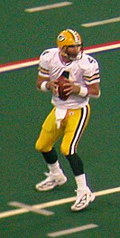 Favre on a field in uniform about to throw the ball