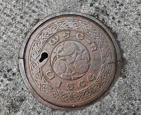 Irish-language manhole cover.