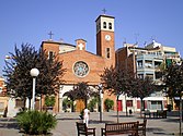 Main façade o the Pairish Kirk o Sant Adrià an the square namit efter the kirk whaur it is situatit.