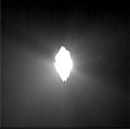 This image shows the view from Deep Impact's probe 30 minutes before it was pummeled by comet Tempel 1. The picture's brightness has been enhanced to show the jets of dust streaming away from the comet. The image was taken by the probe's impactor targeting sensor.