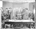 Boxer Jack Johnson on the left shaking hands with another gentleman