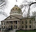 A large granite building with a dome and a pillared portico.