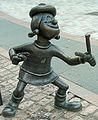 Image 72Statue of Minnie the Minx, a character from The Beano. Launched in 1938, the comic is known for its anarchic humour, with Dennis the Menace appearing on the cover. (from Children's literature)