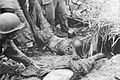 U.S. Marines drag dead Japanese soldiers from their bunker near Point Cruz in November, 1942.