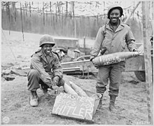 One holds an artillery round with "Happy Easter Adolf" written on it