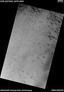 Wide view of defrosting, as seen by HiRISE under HiWish program. Gas and dark dust is probably being blown out of ground and then carried by winds toward the Northwest.