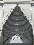 Semi-vault above one of the mosque entrances, with Baroque friezes replacing muqarnas