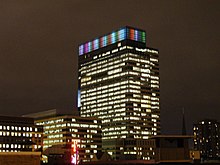 Target tower lit at night in a rainbow at the top