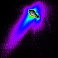 A composite of images from NASA's Deep Space 1 spacecraft shows features of comet Borrelly's nucleus, dust jets escaping the nucleus and the cloud-like "coma" of dust and gases surrounding the nucleus. False color is used to reveal details of the jets and coma. The images were taken when Deep Space 1 was about 4,800 kilometers (3,000 miles) from Borrelly during a Sept. 22, 2001, flyby. Borrelly's nucleus is about 8 kilometers (5 miles) from end to end, so the field of view is about 40 kilometers (25 miles) across. The Sun shines from the bottom of the image. The main dust jet, seen extending toward the bottom left, heads away from the comet in a direction that is about 30 degrees off the direction straight toward the Sun from the comet. The colors show about three orders of magnitude in the brightness of the dust jets and coma. Red indicates about one-tenth the brightness as the brightness of the nucleus, blue one-one-hundredth, purple one-one-thousandth. The red bumps near the nucleus indicate where the jet resolves into three distinct, narrow jets, which likely come from discrete source points on the surface. Deep Space 1 completed its primary mission testing ion propulsion and 11 other advanced, high-risk technologies in September 1999. NASA extended the mission, taking advantage of the ion propulsion and other systems to undertake this encounter with the comet. More information can be found on the Deep Space 1 home page. Deep Space 1 was launched Oct. 24, 1998, as part of NASA's New Millennium Program, which is managed by JPL for NASA's Office of Space Science, Washington, D.C. The California Institute of Technology manages JPL for NASA.