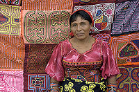 A woman standing in front of a wall of fabric