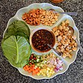 'Miang pla' literally means "wrapped fish". This dish is often eaten as an appetizer. Here the leaves of the chaphlu ("Piper sarmentosum") and khana ("Chinese broccoli") are used as wraps.