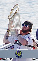 Jarrod Saltalamacchia lifts the Commissioner's Trophy aboard a duck boat