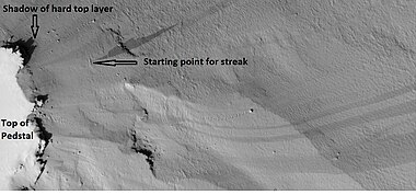 Dark slope streaks near the top of a pedestal crater, as seen by HiRISE under the HiWish program