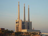 The three chimneys o the nouadays closed Besòs pouer termal station hae become a icon for the ceety. In 2008, the ceetizens o Sant Adrià decidit tae keep thaim in a referendum.[14]