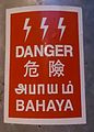 An electrical hazard sign in Malaysia written in Tamiḻ with other languages