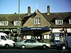 A brown-bricked building with a rectangular, dark blue sign reading "KINGSBURY STATION" in white letters all under a light blue sky