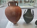 Large storage-jar or amphora with painted decoration and a bronze biconical cinerary urn