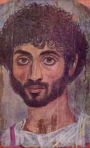 Fayum mummy portrait of man thin face and with curly hair at MET museum gallery 138